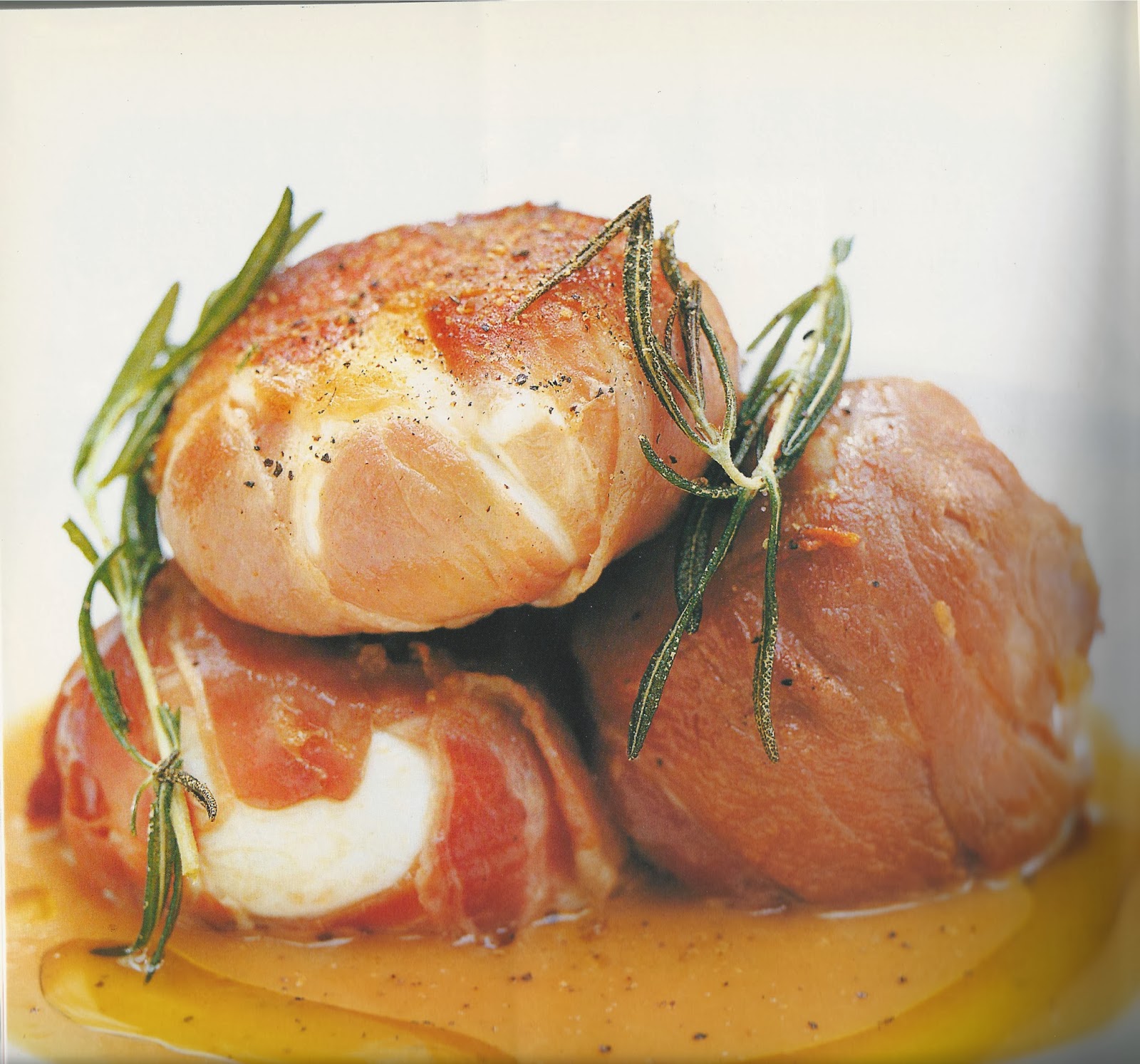 Baked mozzarella balls wrapped in prosciutto with a herb tomato sauce